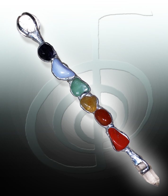 A close up of a key chain with seven different colored stones