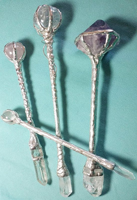 A set of five silver spoons on top of a table.